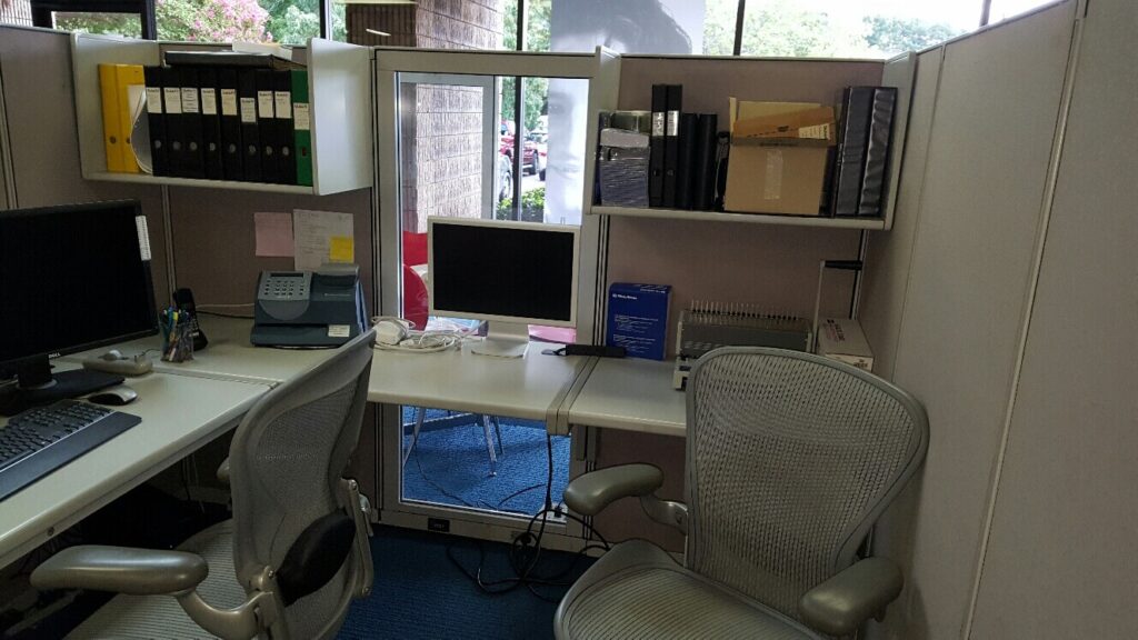 Office cubicle, monitors, documents, and junk in Norcross