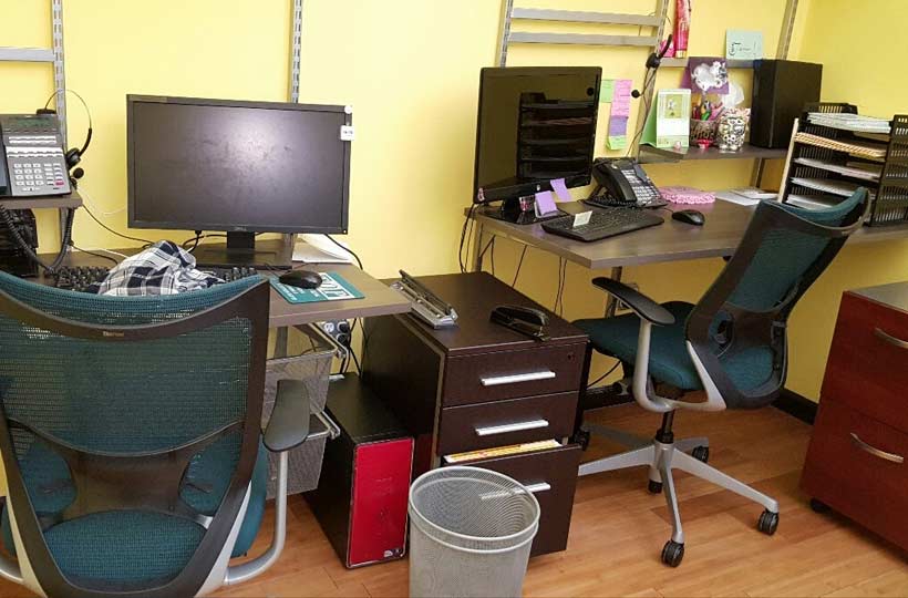 Office furniture, desks, and computers ready for commercial junk removal in Alpharetta, GA